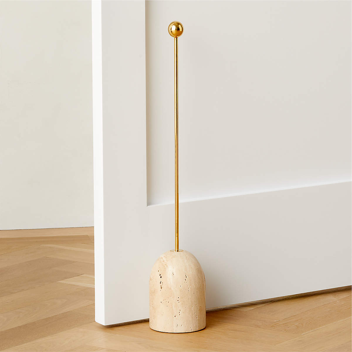 travertine-doorstop-with-unlacquered-polished-brass-handle.jpg